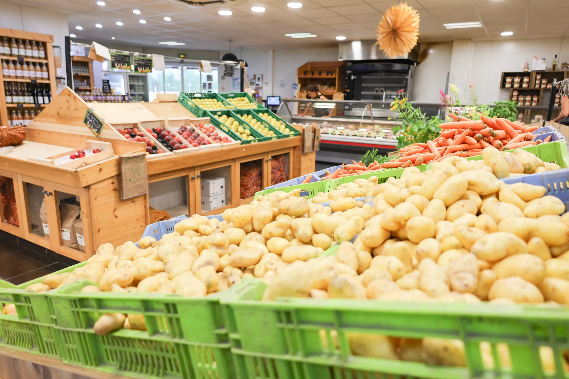 Les étals du Comptoir de nos Fermes, pommes de terre et carottes au premier plan